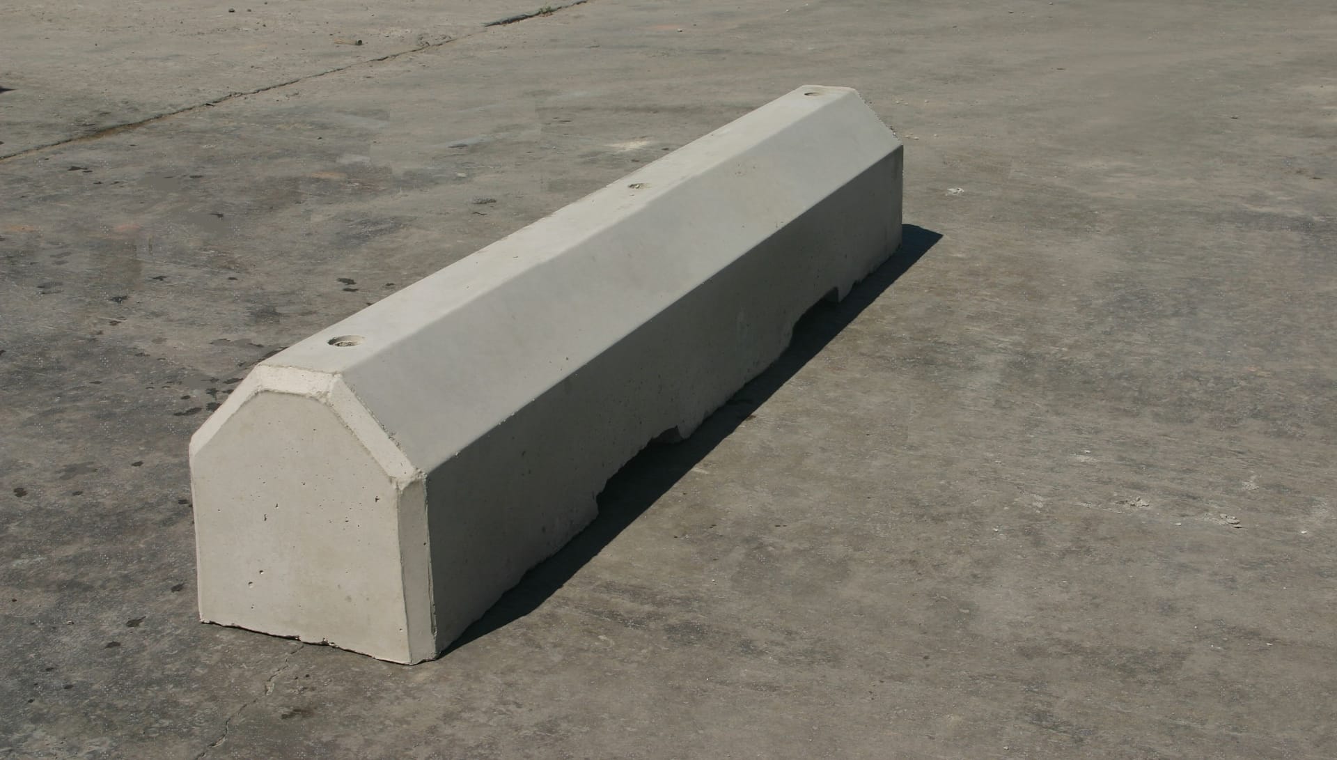 APC TB-Series truck wheel stops installed at a loading dock
